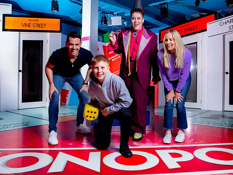 Immersive Experiences | people laughing while playing a life-sized Monopoly game